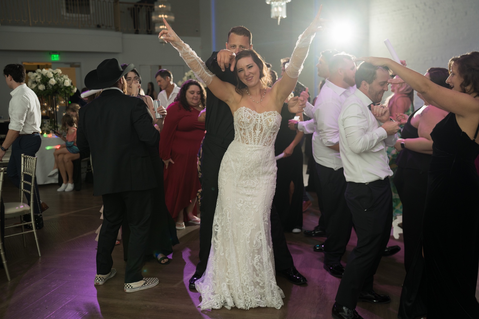 Bride and groom celebrating on the dance floor with their guests